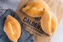 Freshly baked Portuguese bread loaves from Caldense Bakery on Dundas.