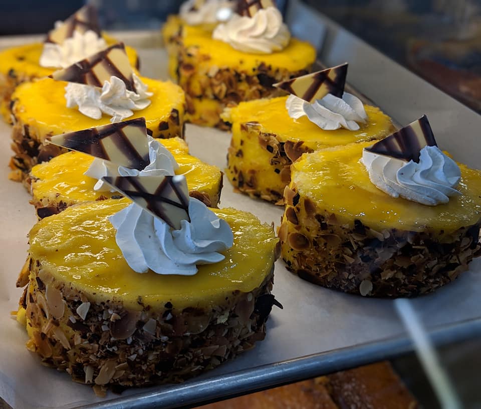 Creamy sweet egg pastries adorned with chocolate at Dynasty Bakery.