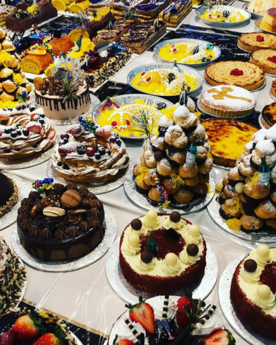 Assorted pastries and cakes display at Doce Minho Portuguese Bakery, Toronto.