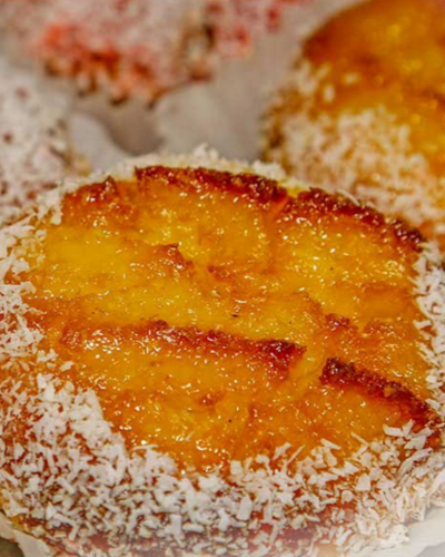 Glazed coconut pastry dusted with sugar at Seara Bakery in Toronto.