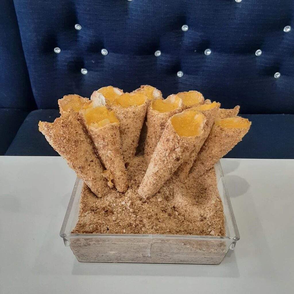 Golden sweet egg cream cones dusted with sugar at The Portuguese Bake Shop, Toronto.